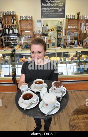 Young waitress carrying a tray of coffee at Di Lieto's Coffee Lounge, The Waterfront, Sovereign Harbour, Eastbourne Stock Photo