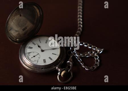 Pocket watch on top of a wooden box Stock Photo