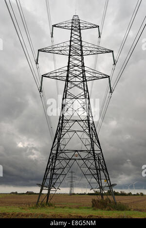 Wind farm and National Grid electricity transmission lines and pylons. Romney Marsh Near Rye, Sussex. Stock Photo