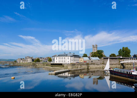 The River Shannon waterfront with King John's Castle in the distance, Limerick City, County Limerick, Republic of Ireland Stock Photo