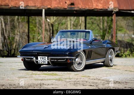 1966 Chevrolet Corvette Sting Ray standing in front of derelict industrial shed Stock Photo