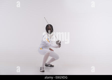 Young woman engaging in fencing Stock Photo