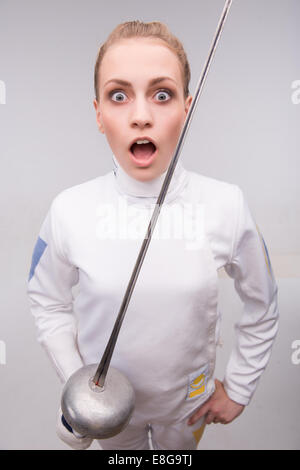 Young woman engaging in fencing Stock Photo