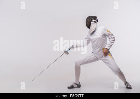 Young woman engaging in fencing Stock Photo