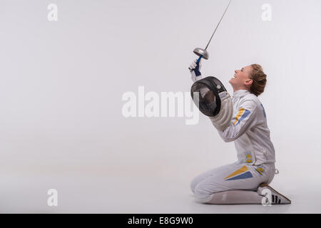 Young woman engaging in fencing Stock Photo