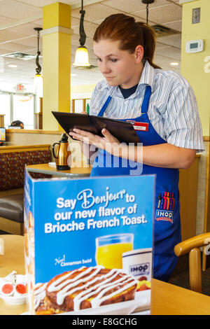 Naples Florida,IHOP,restaurant restaurants food dining eating out cafe cafes bistro,interior inside,adult adults woman women female lady,waitress serv Stock Photo