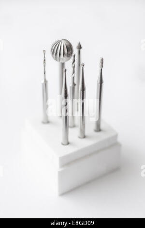 Delicate drill bits used in jewelery-making on a white stand Stock Photo