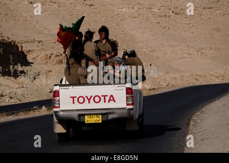 An open-backed Toyota pickup truck carrying a group of female Kurdish ...