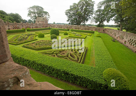 Formal 17th century walled gardens with low hedges, topiary, roses, lawns under blue sky at historic Edzell castle, Scotland Stock Photo