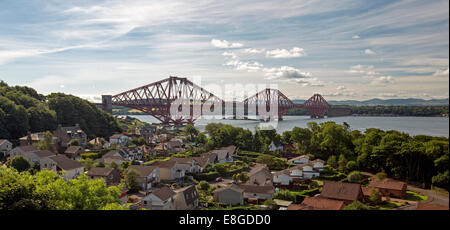 Panoramic view of iconic 19th century bridge over Firth of Forth with house of town of Queenstown in foreground Scotland Stock Photo