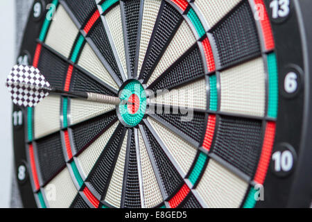 The dart hits the dartboard center Stock Photo