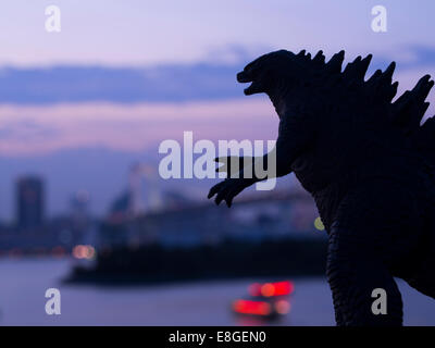 Godzilla ( toy )  looms over the Tokyo Bay, Odaiba, Tokyo, JAPAN. Stock Photo