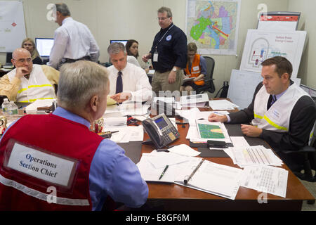 Goshen, New York, USA. 7th Oct, 2014. Orange County Executive STEVE NEUHAUS, at right, listens to a conference call during a full-scale Federal Emergency Management Agency (FEMA) exercise designed to test the county's emergency preparedness plan in the event of a disaster or attack at the nuclear-powered Indian Point Energy Center in Westchester County. The drill took place at the Orange County Emergency Services Center in Goshen, New York. Westchester, Rockland and Putnam counties also participated in the drill, which focused on Hostile Action-Based (HAB) emergency responses while simul Stock Photo