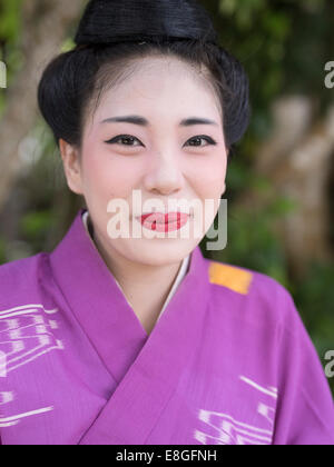 Young Okinawan woman in traditional kimono and with traditional hairstyle and makeup at Ryukyu Mura ( Ryukyu Village )  Okinawa Stock Photo