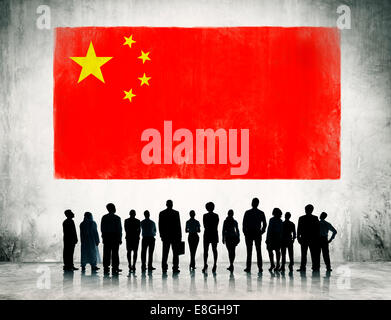 Business people standing infront of the flag of China. Stock Photo
