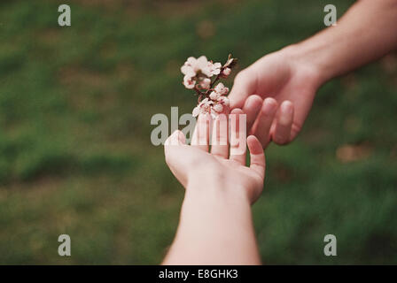 Man giving a woman a flower, Romania Stock Photo