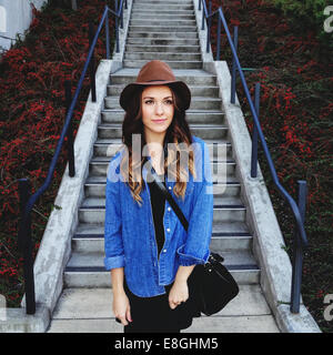 USA, Portrait of young woman wearing hat