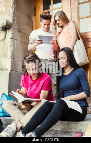 Students studying at the entrance of university Stock Photo