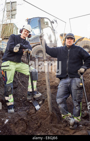 Portrait of confident construction workers at site Stock Photo