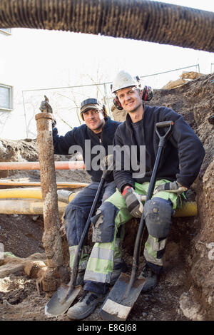 Portrait of smiling workers at construction site Stock Photo