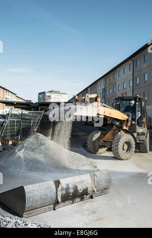 Construction worker using excavator at site Stock Photo