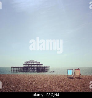 UK, England, East Sussex, Brighton, Two deck chairs on Brighton Beach Stock Photo