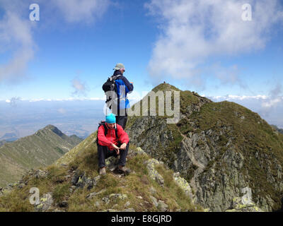 Romania, Moldoveanu, Hikers on mountain trail Stock Photo