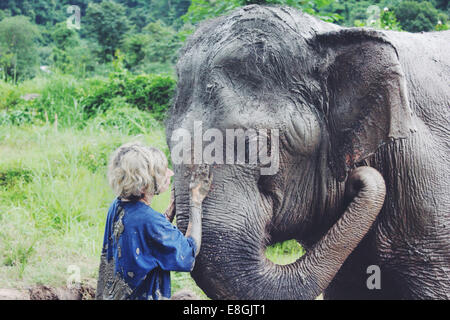 Thailand, Woman washing elephant Stock Photo