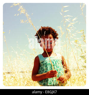 Portrait of a girl standing in long grass, Burlingame, San Mateo County, California, USA Stock Photo
