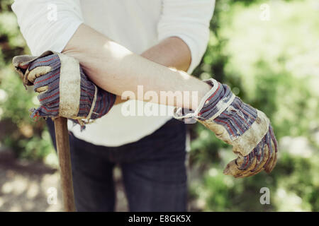 Midsection of man wearing gardening gloves at yard Stock Photo