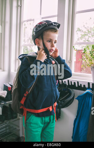 Boy wearing cycling helmet at home Stock Photo