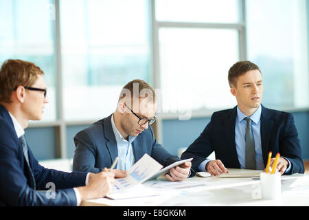 Three men at meeting in office Stock Photo