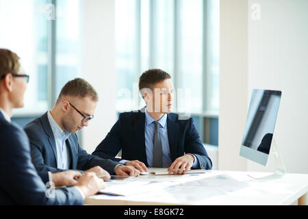 Three office workers having meeting Stock Photo