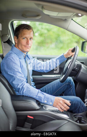 Portrait of confident man sitting in car Stock Photo