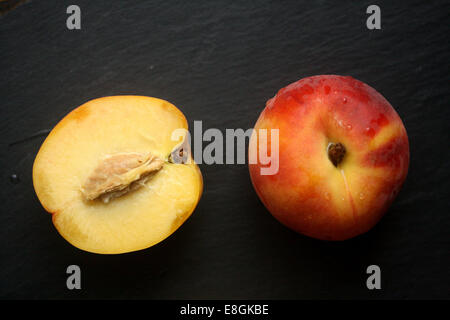 Fresh peach and halved peach Stock Photo