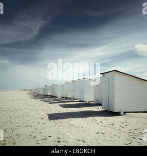 Row of white beach huts on beach, s-Gravenzande, Holland Stock Photo