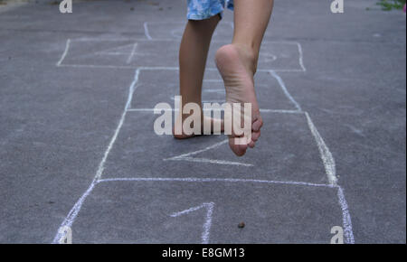 Child playing hopscotch Stock Photo