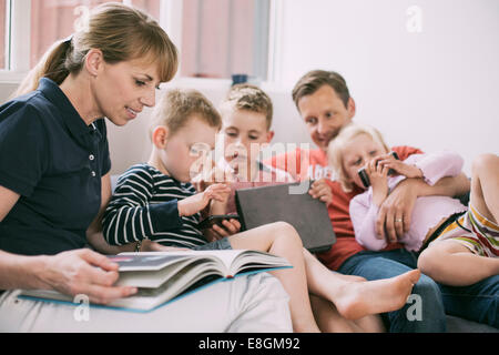 Family spending leisure time in living room Stock Photo