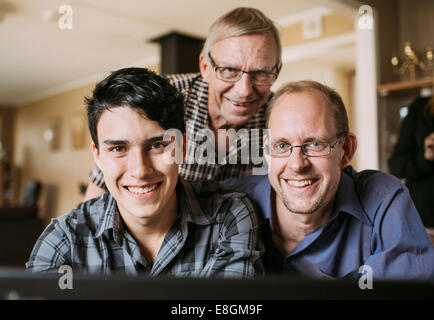 Portrait of three generation family smiling together at home Stock Photo