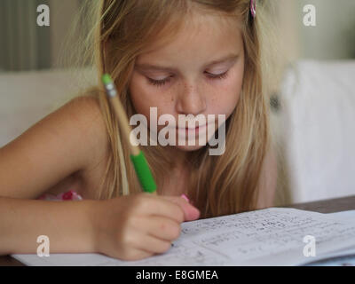 Girl writing in a notebook, Sweden Stock Photo