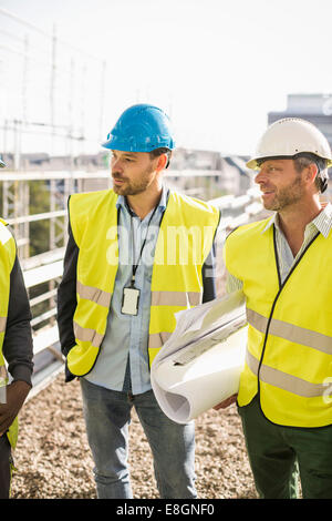 Architects standing at construction site Stock Photo