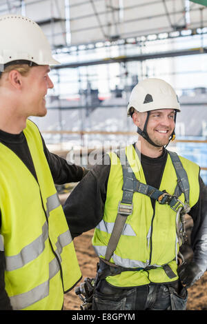 Smiling construction workers at site Stock Photo