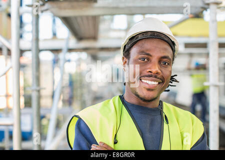 Portrait of happy construction worker at site Stock Photo