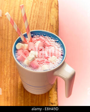 A mug of strawberry milkshake with mini marshmallows and straws Stock Photo