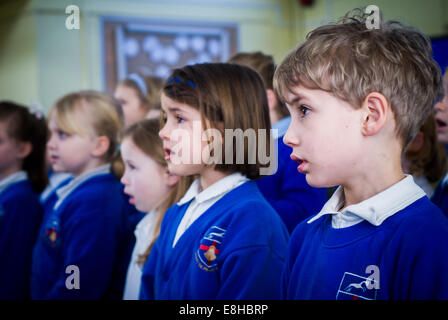 Children singing at a primary school assembly, UK Stock Photo