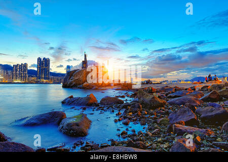 Hong Kong Sunset, Yau Tong Lei Yue Mun water bay and lighthouse Stock Photo