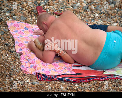 A passionate kiss on the beach at Brighton Stock Photo