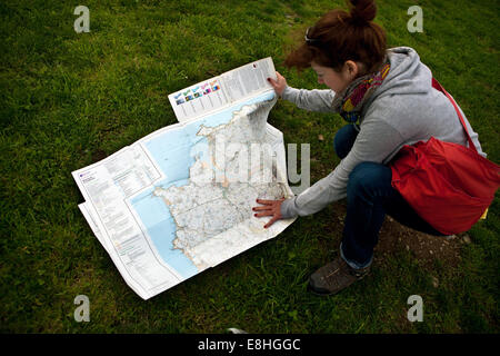 Woman reading on paper map Stock Photo - Alamy