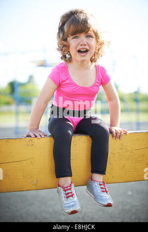 unhappy girl crying on the playground Stock Photo