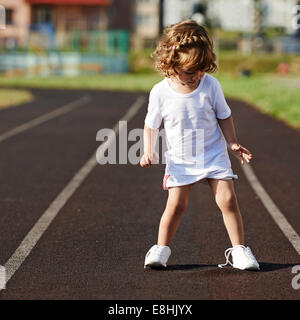 beautiful little girl learning to tie shoelaces Stock Photo
